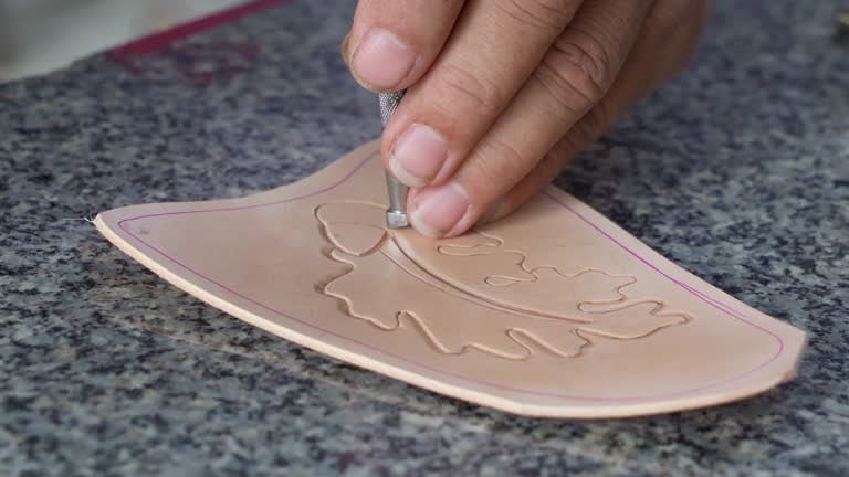 Using a bevelling tool to begin tooling a leather design